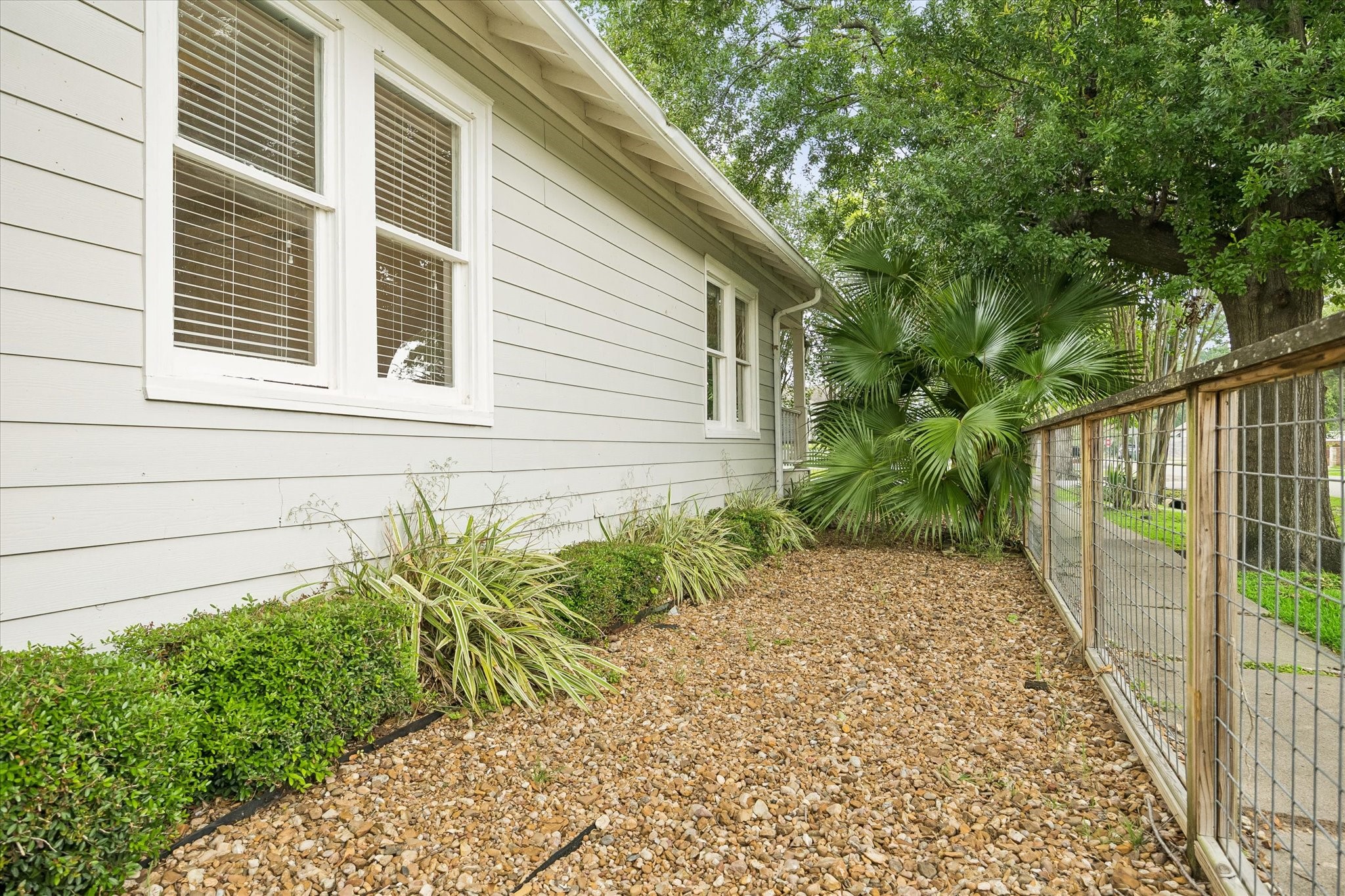 1201 Tulane Street Houston, TX 77008 - Photo 6 of 31 The easy care side yard keeps outdoor upkeep simple with a gravel base, tidy landscaping, and a fully fenced layout. It is a great little bonus space for potted plants, pets, storage, or simply keeping the yard low maintenance.