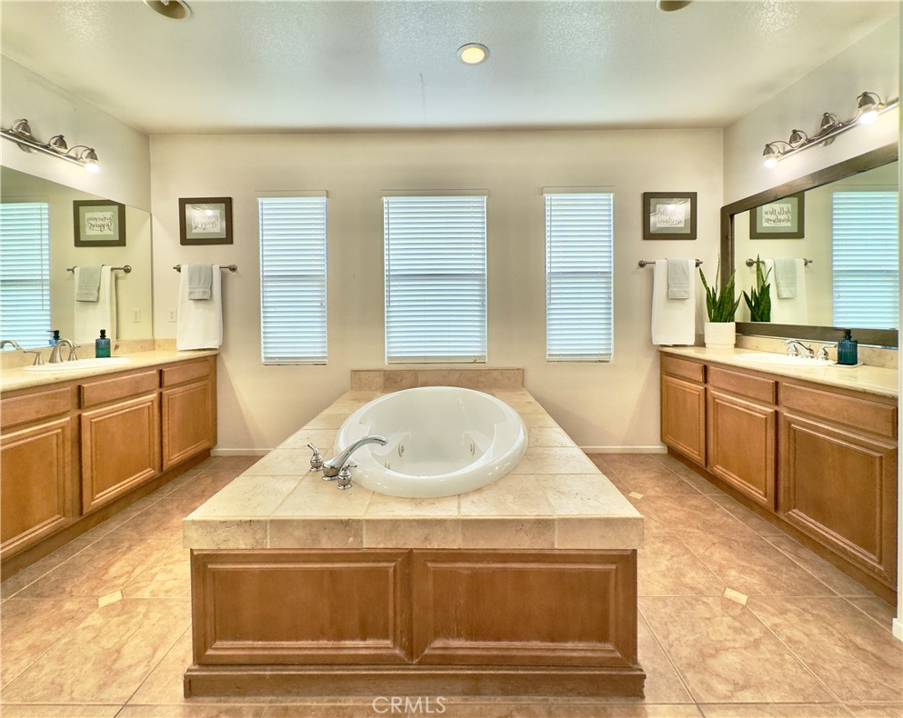 11265 Runyan Road Beaumont, CA 92223 - Photo 81 of 138 Grand Primary Bedroom Suite Bathroom with large soaking tub, separate vanities, water closet, and large walk-in closet and shower.