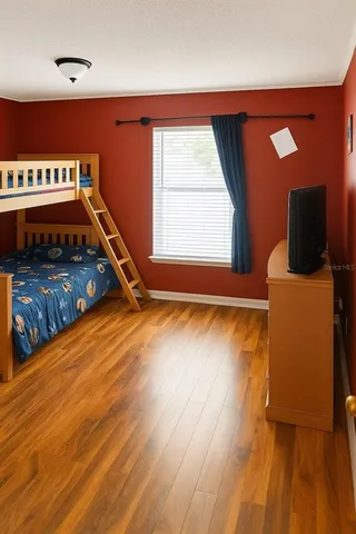 a room with wooden floor and pool table