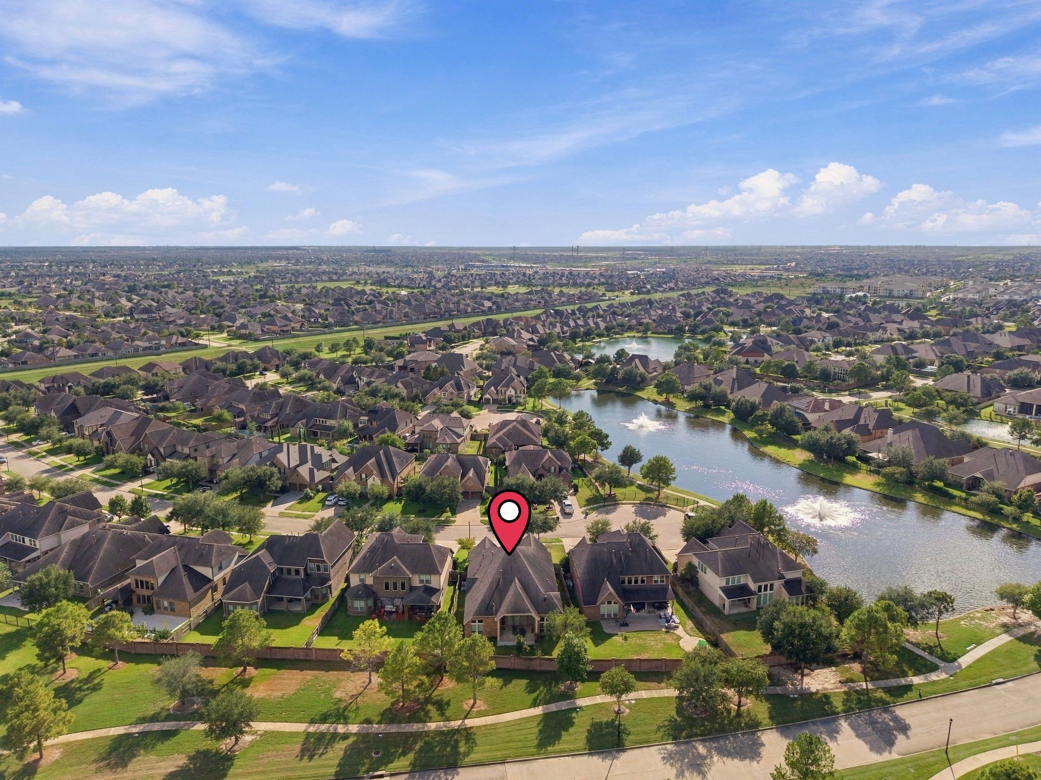 This aerial view shows how well-connected the home is within Cypress Creek Lakes, with easy access to the community's scenic lake and walking trails just steps from your door.