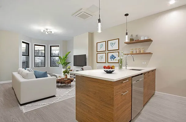 a kitchen with stainless steel appliances granite countertop a sink a stove and a wooden floor