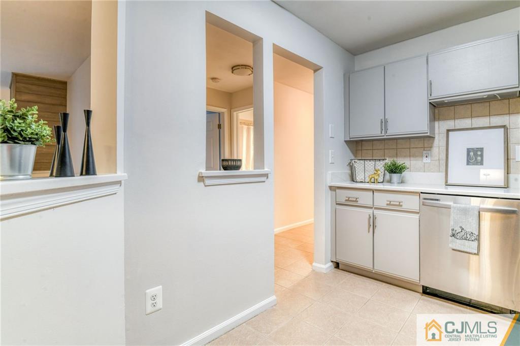 1602 Stoneridge Circle Helmetta, NJ 08828 - Photo 9 of 22 a kitchen with white cabinets and window