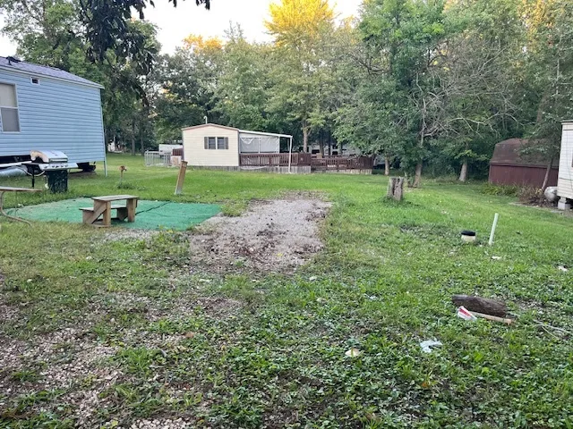 a view of a backyard with a garden and trees