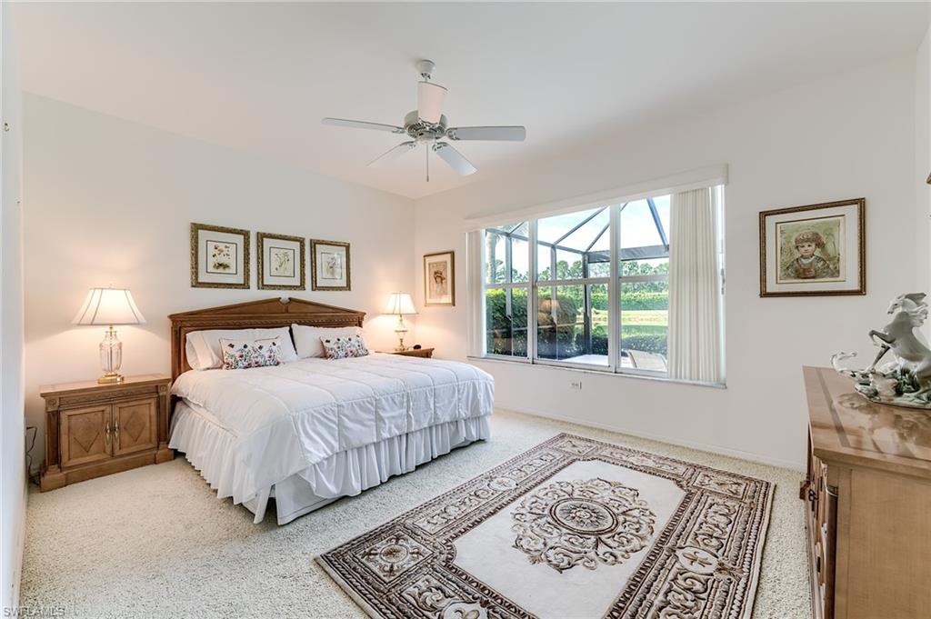 9156 Spring Run Boulevard Estero, FL 34135 - Photo 12 of 34 a bedroom with a large bed and a window