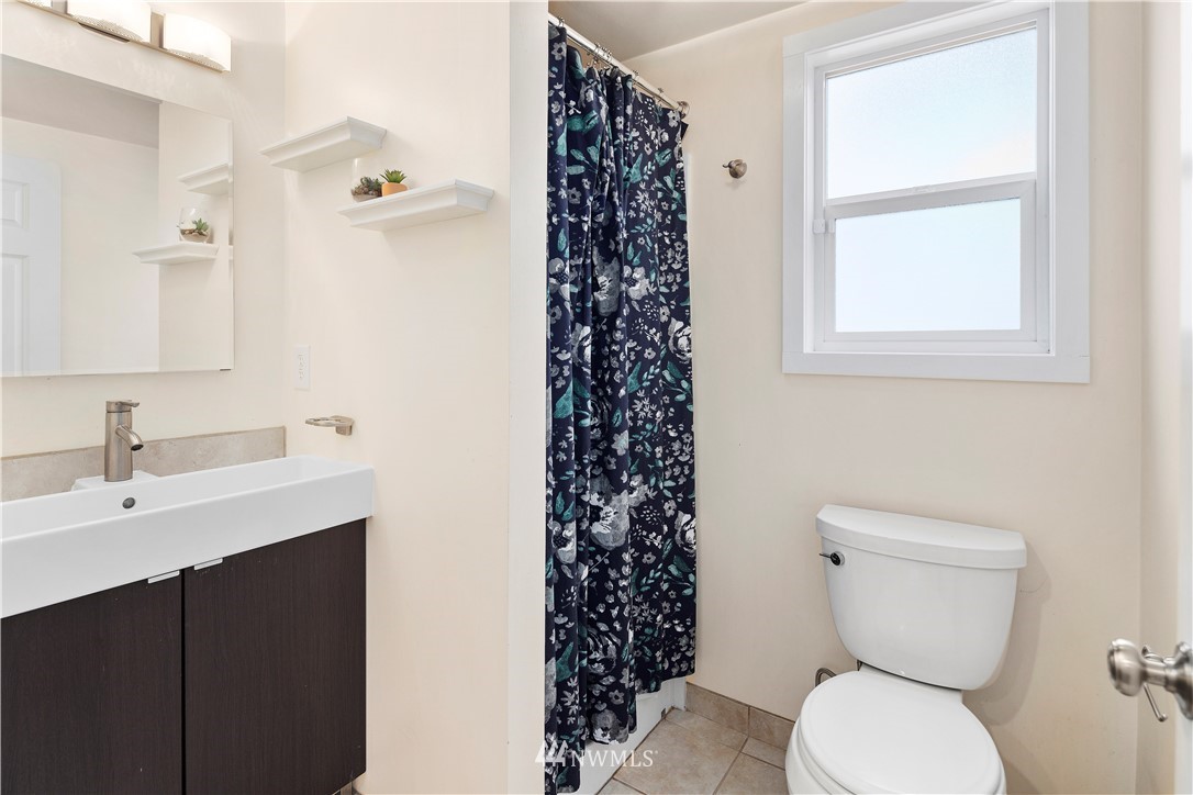 501 Grandey Way Northeast Renton, WA 98056 - Photo 22 of 40 a bathroom with a sink a toilet and a window