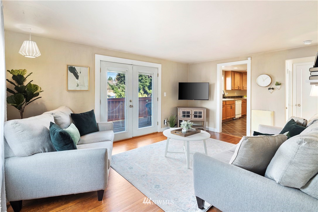 501 Grandey Way Northeast Renton, WA 98056 - Photo 4 of 40 a living room with furniture flat screen tv and wooden floor