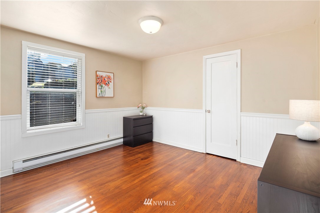 501 Grandey Way Northeast Renton, WA 98056 - Photo 8 of 40 a view of an empty room with wooden floor and a window