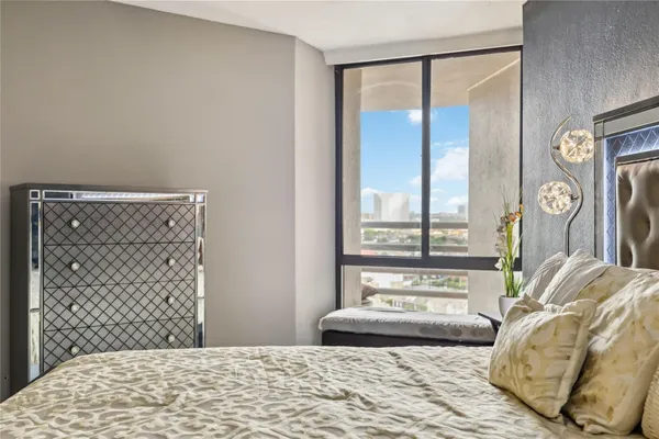 a bedroom with a bed and a large mirror