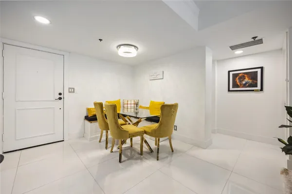 a view of a room with a table and chairs