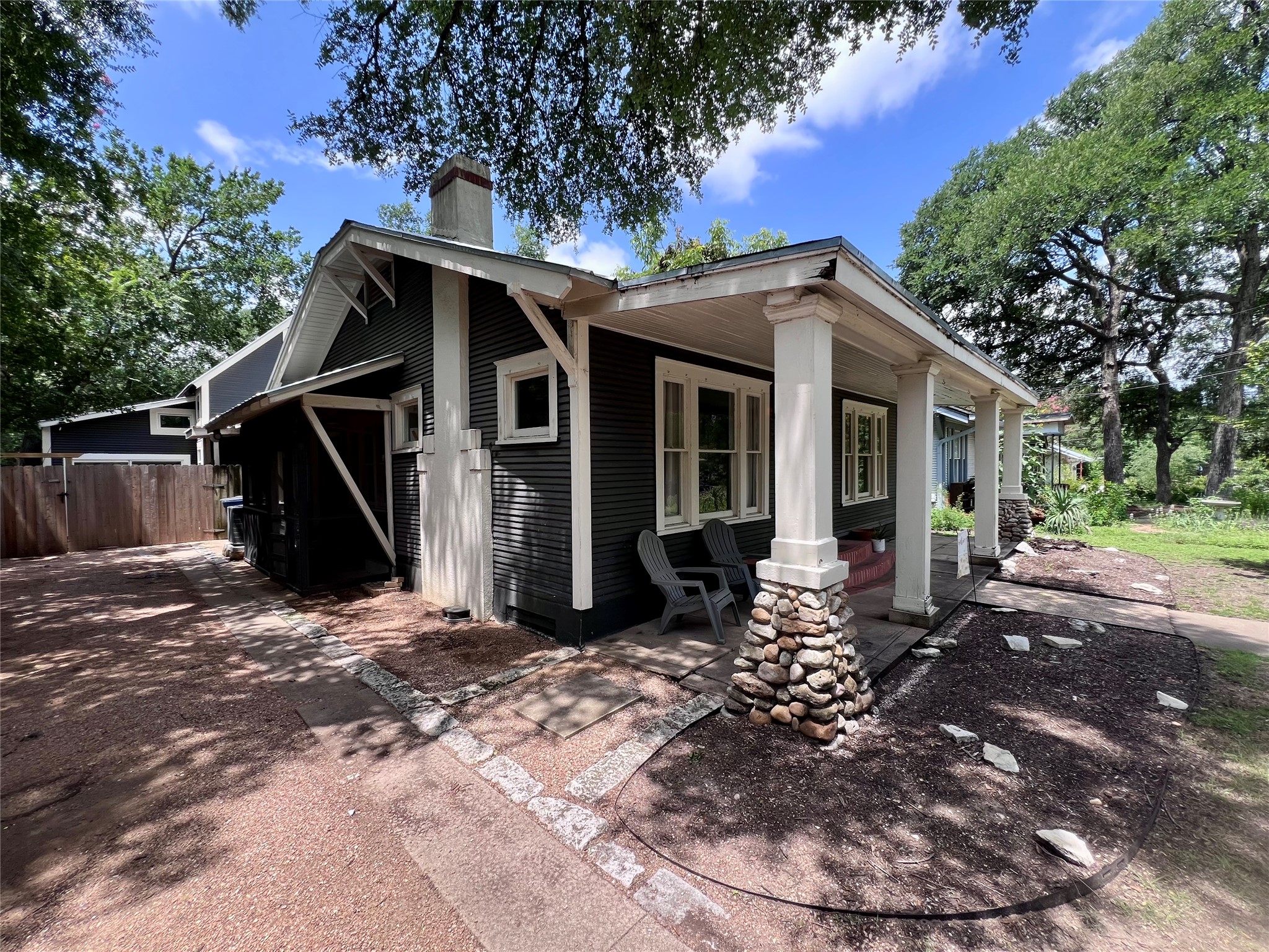 307 East 35th Street, Unit A Austin, TX 78705 - Photo 3 of 31 A charming Craftsman-style home with a welcoming stone-accented porch and mature shade trees.
