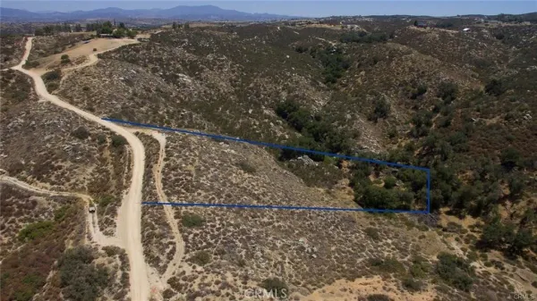 a view of a yard with wooden fence