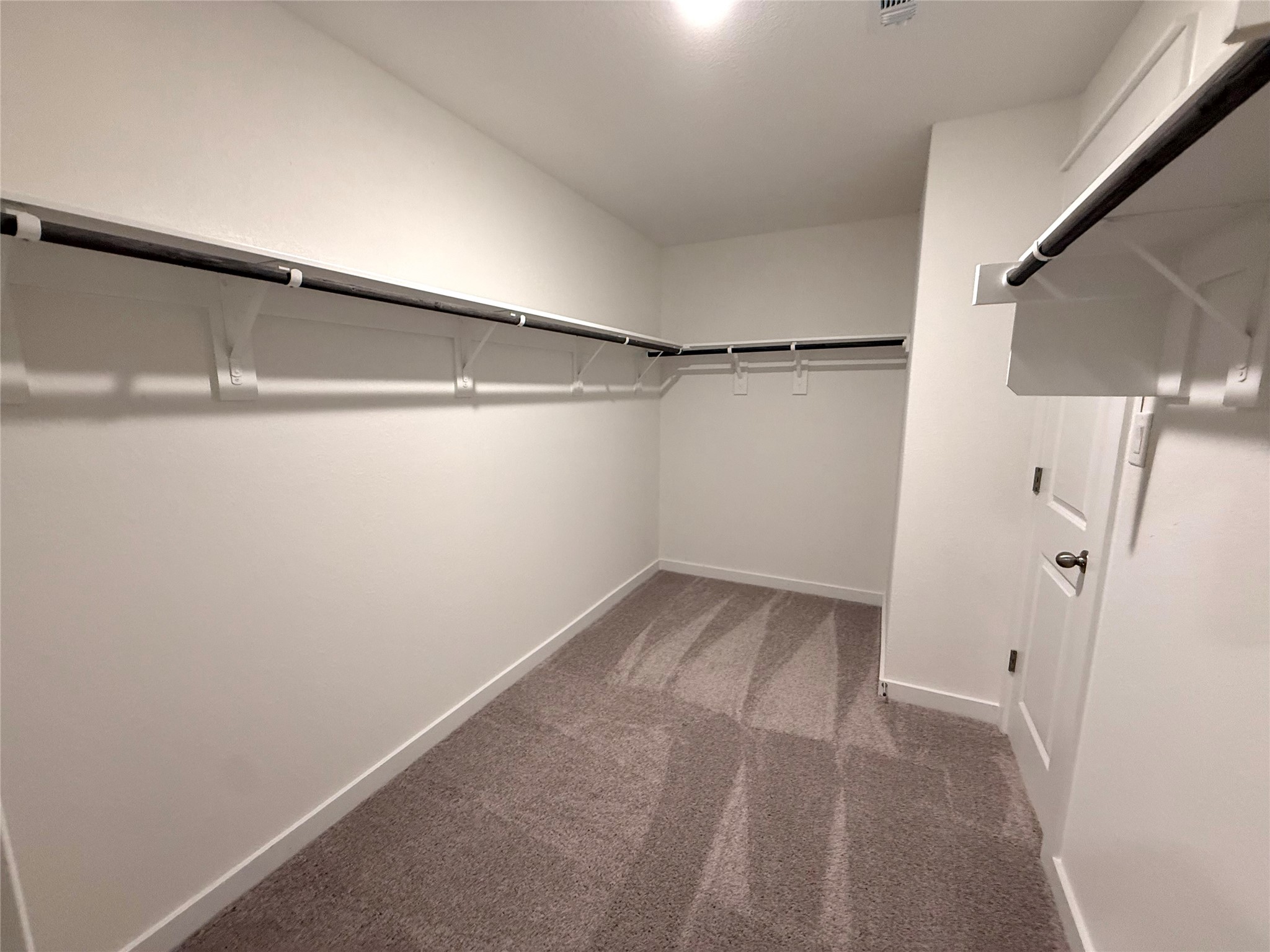 13605 Barn Chime Street Elgin, TX 78621 - Photo 12 of 20 a view of a room with racks on the wall