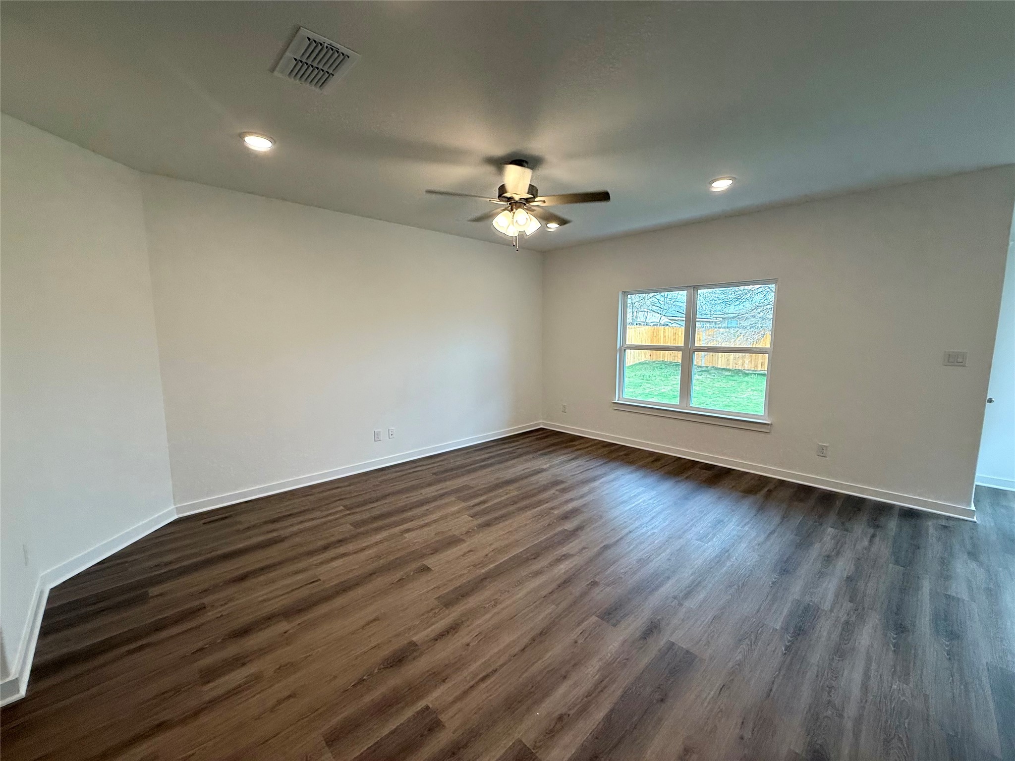 13605 Barn Chime Street Elgin, TX 78621 - Photo 5 of 20 an empty room with wooden floor and a ceiling fan
