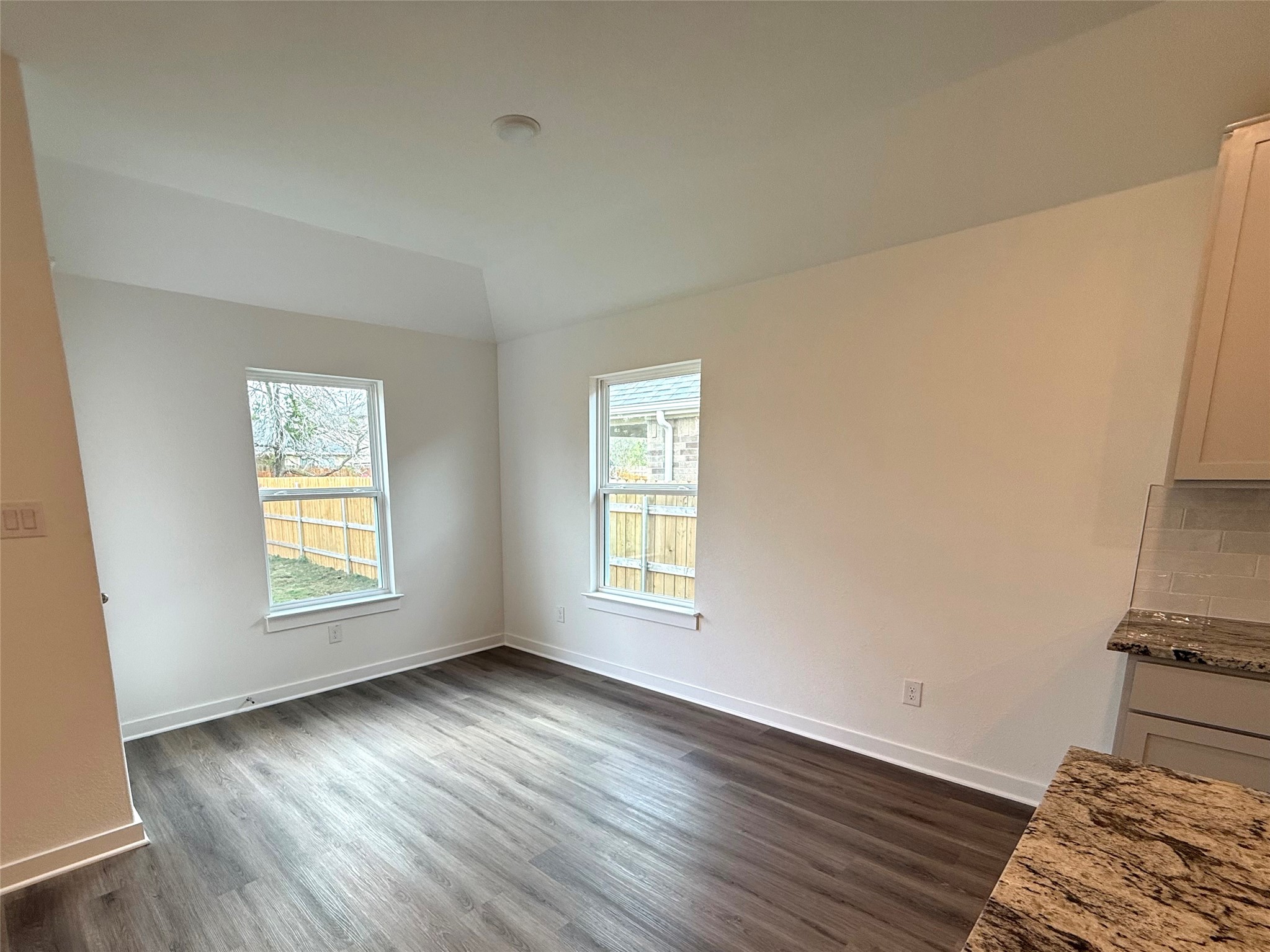 13605 Barn Chime Street Elgin, TX 78621 - Photo 6 of 20 an empty room with wooden floor and window