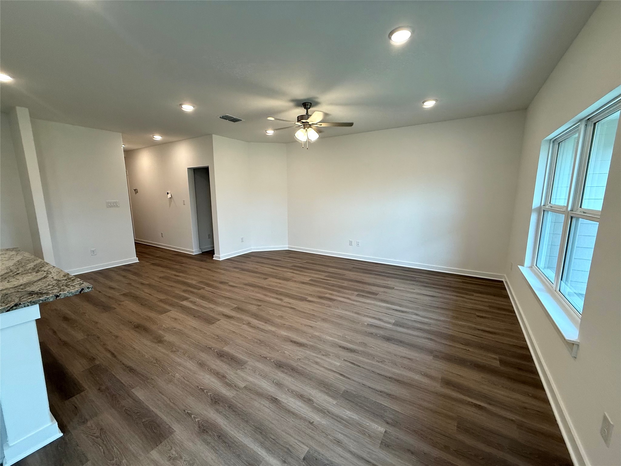13605 Barn Chime Street Elgin, TX 78621 - Photo 8 of 20 wooden floor in an empty room with a window