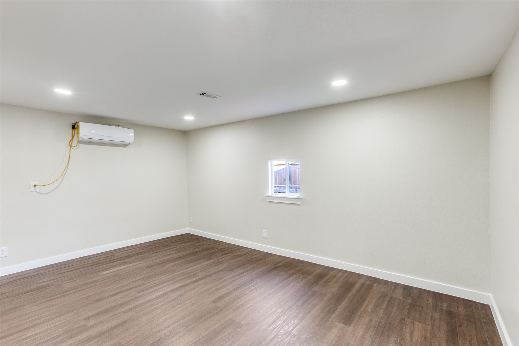 1118 Spur Street Austin, TX 78721 - Photo 5 of 21 Recessed lighting and warm wood flooring enhance this versatile room.