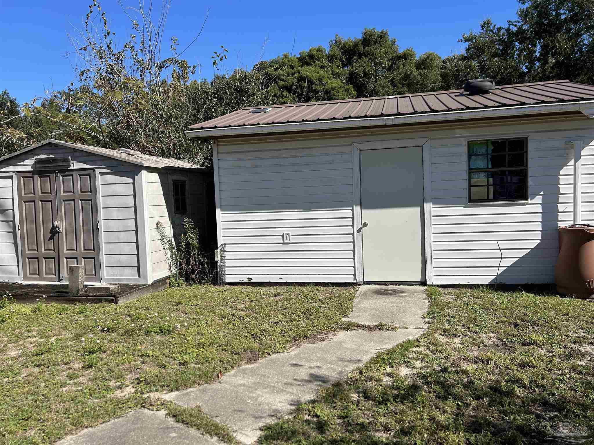 4574 Simpson Street Milton, FL 32583 - Photo 3 of 7 a view of a house with a yard