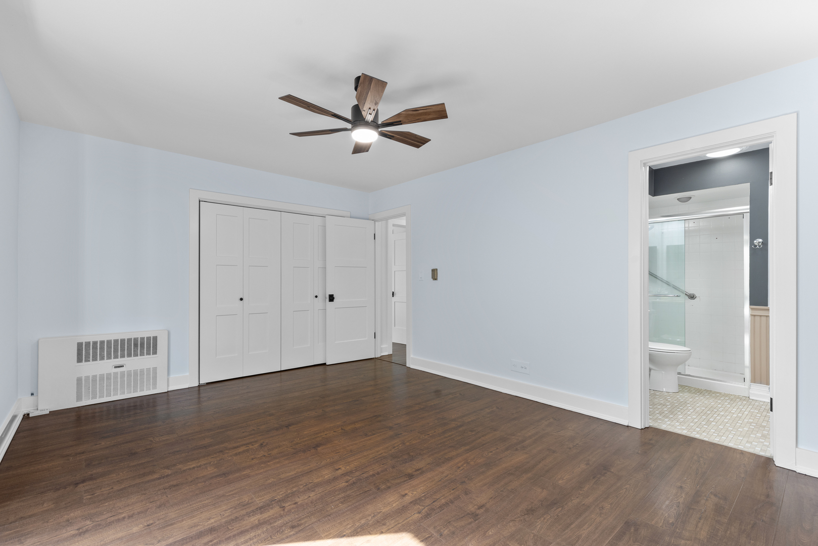 2300 Windsor Mall, Unit 2E Park Ridge, IL 60068 - Photo 17 of 27 a view of a room with wooden floor and a ceiling fan