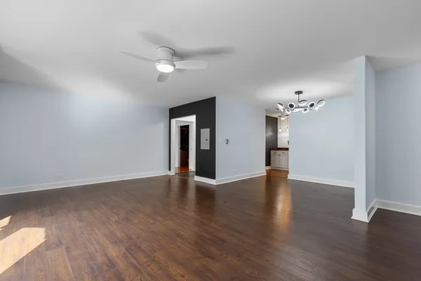 a view of an empty room with wooden floor