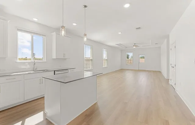 a kitchen with stainless steel appliances a stove microwave and refrigerator