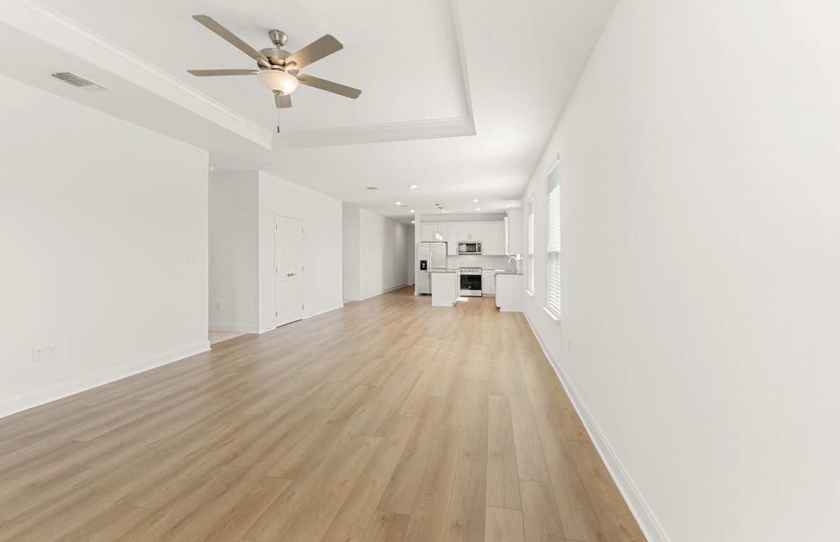 100 Eagle Valley Drive Elgin, TX 78621 - Photo 5 of 7 a view of a room with wooden floor and ceiling fan
