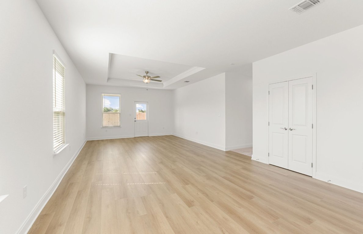100 Eagle Valley Drive Elgin, TX 78621 - Photo 6 of 7 an empty room with wooden floor and windows