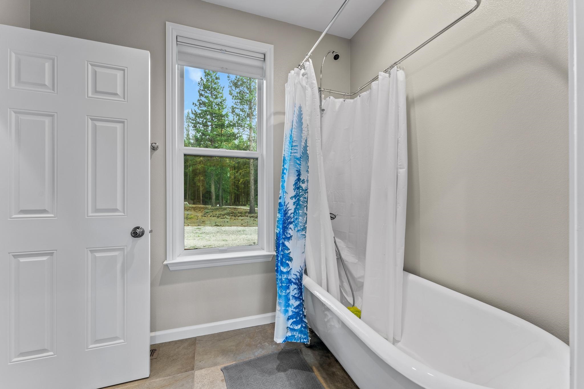 1341 Valley Ranch Drive Clio, CA 96106 - Photo 25 of 50 a bathroom with a bathtub and a shower