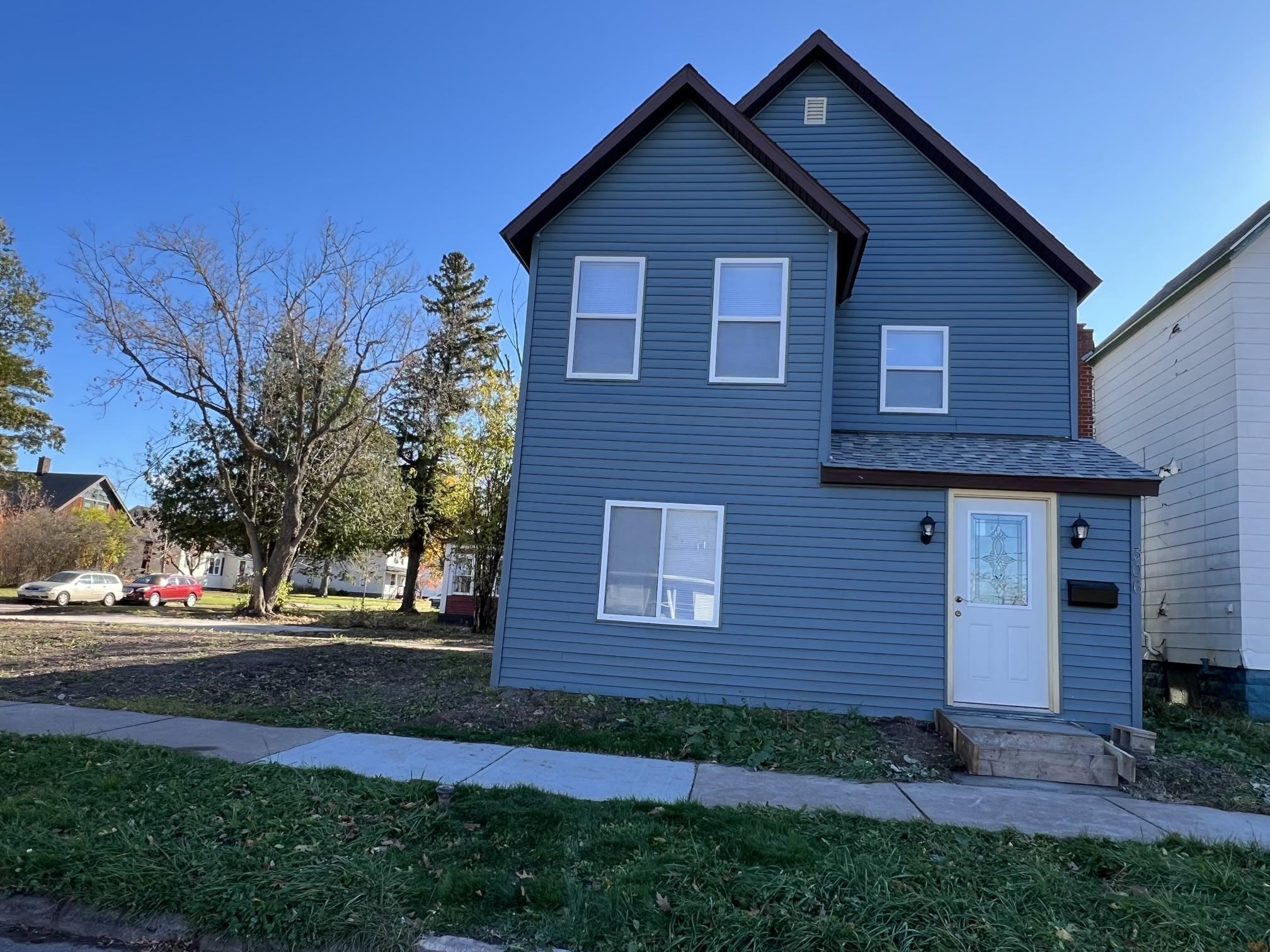 306 7th Street West Ashland, WI 54806 - Photo 1 of 25 Traditional home featuring roof with shingles and a front yard