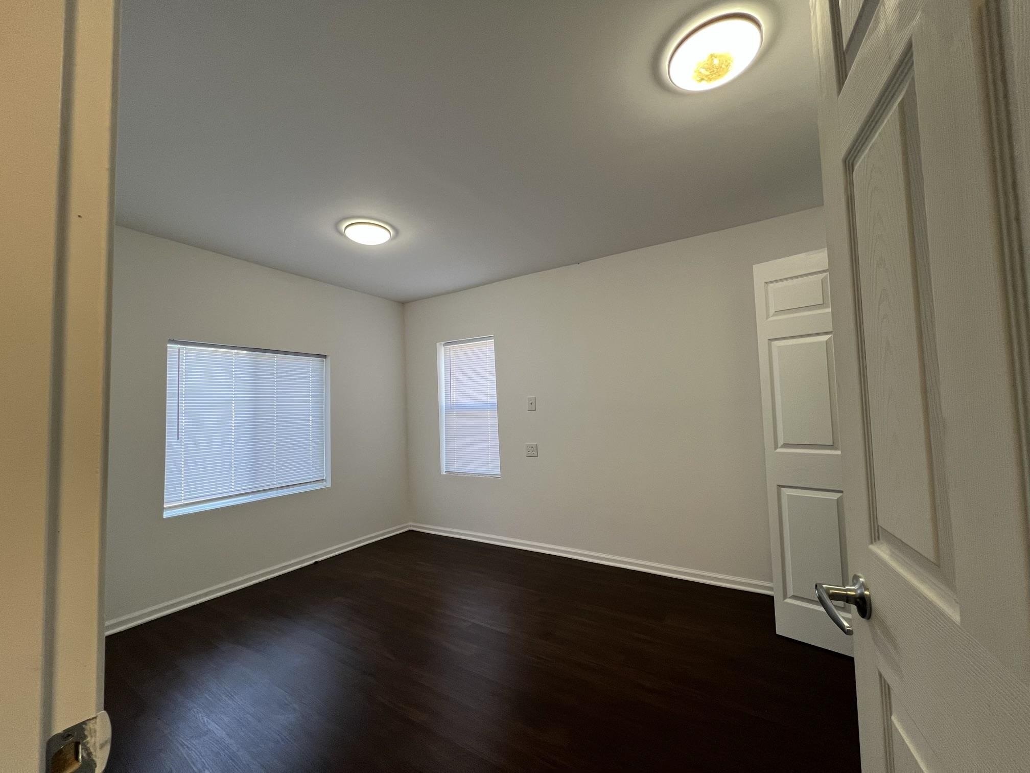 306 7th Street West Ashland, WI 54806 - Photo 11 of 25 Unfurnished room featuring dark wood-style flooring and baseboards