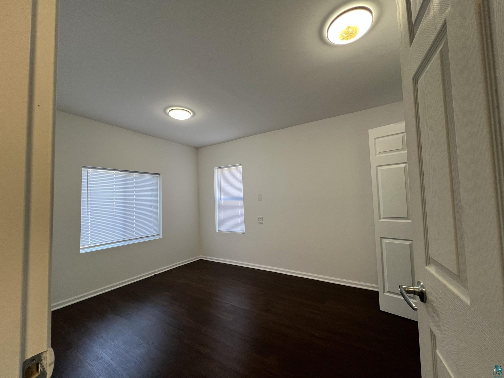 306 7th Street West Ashland, WI 54806 - Photo 11 of 25 Unfurnished room featuring dark wood-style flooring and baseboards