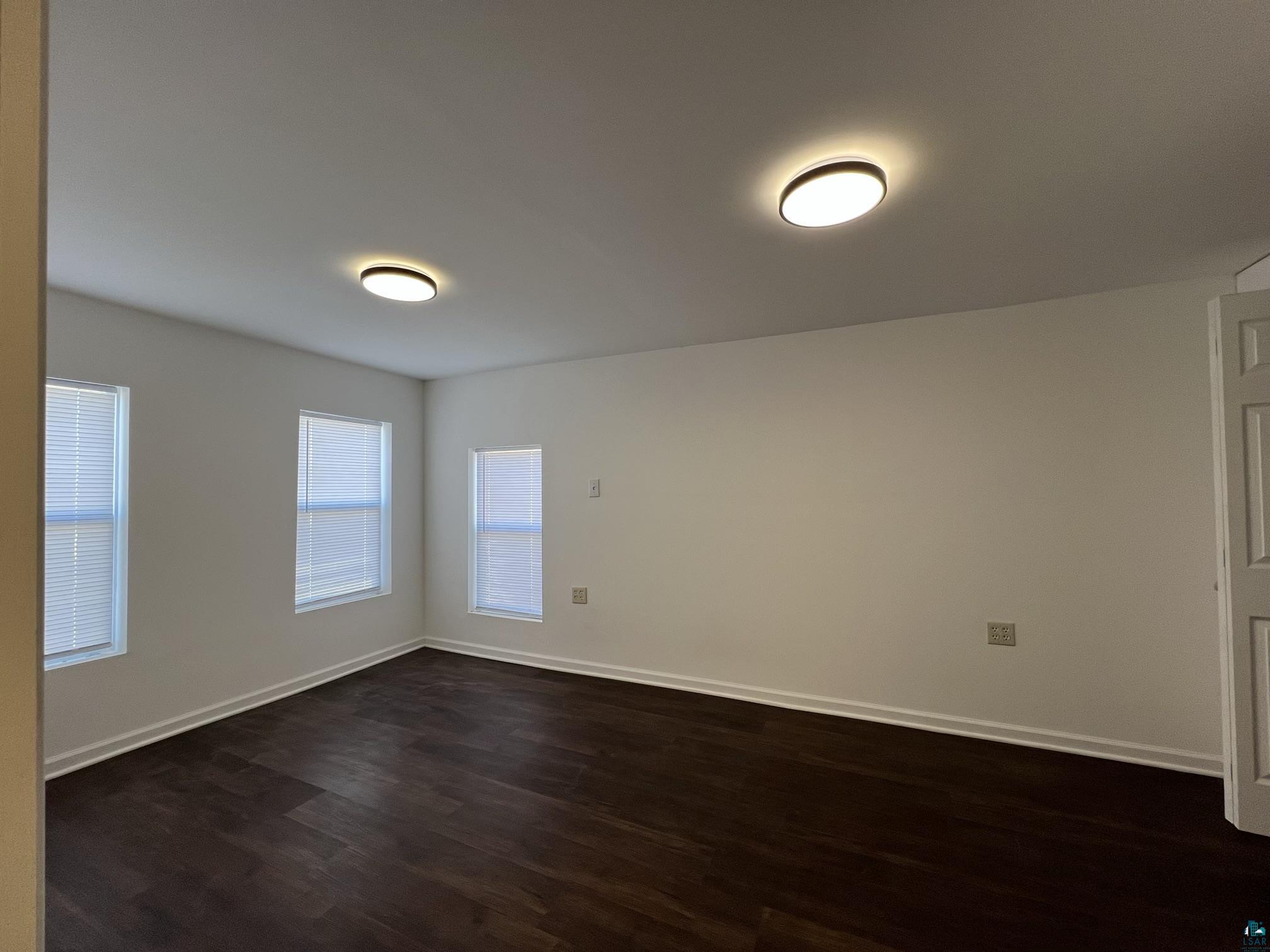 306 7th Street West Ashland, WI 54806 - Photo 14 of 25 Spare room featuring dark wood finished floors and baseboards