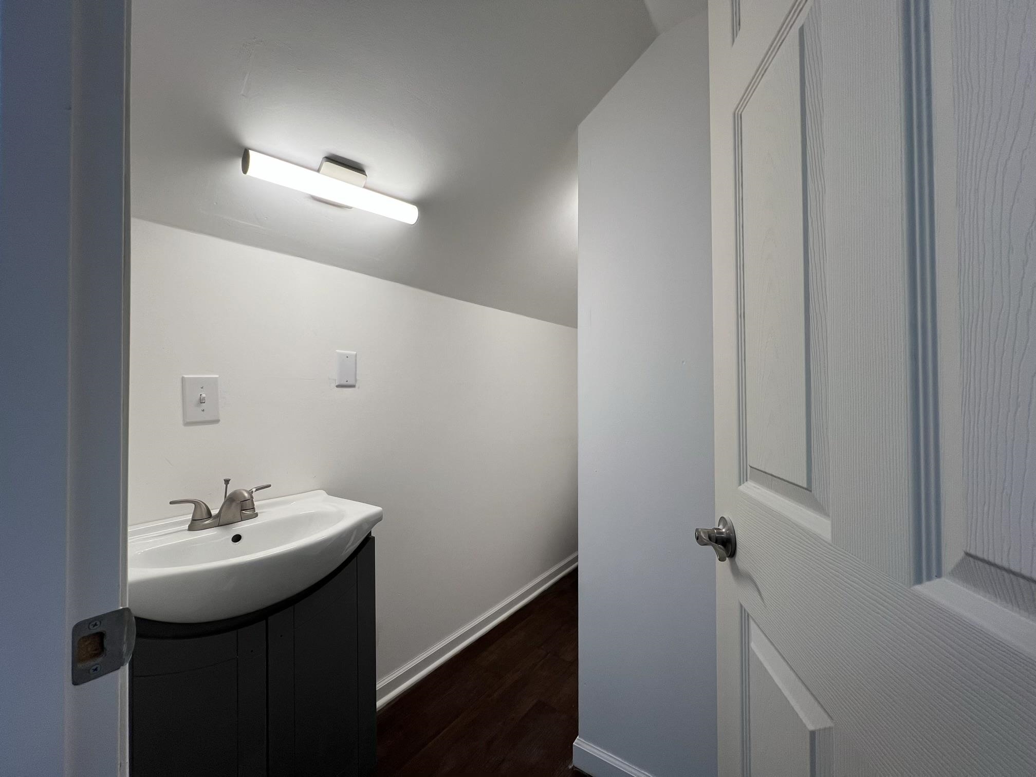 306 7th Street West Ashland, WI 54806 - Photo 17 of 25 Bathroom featuring vanity and dark wood-type flooring