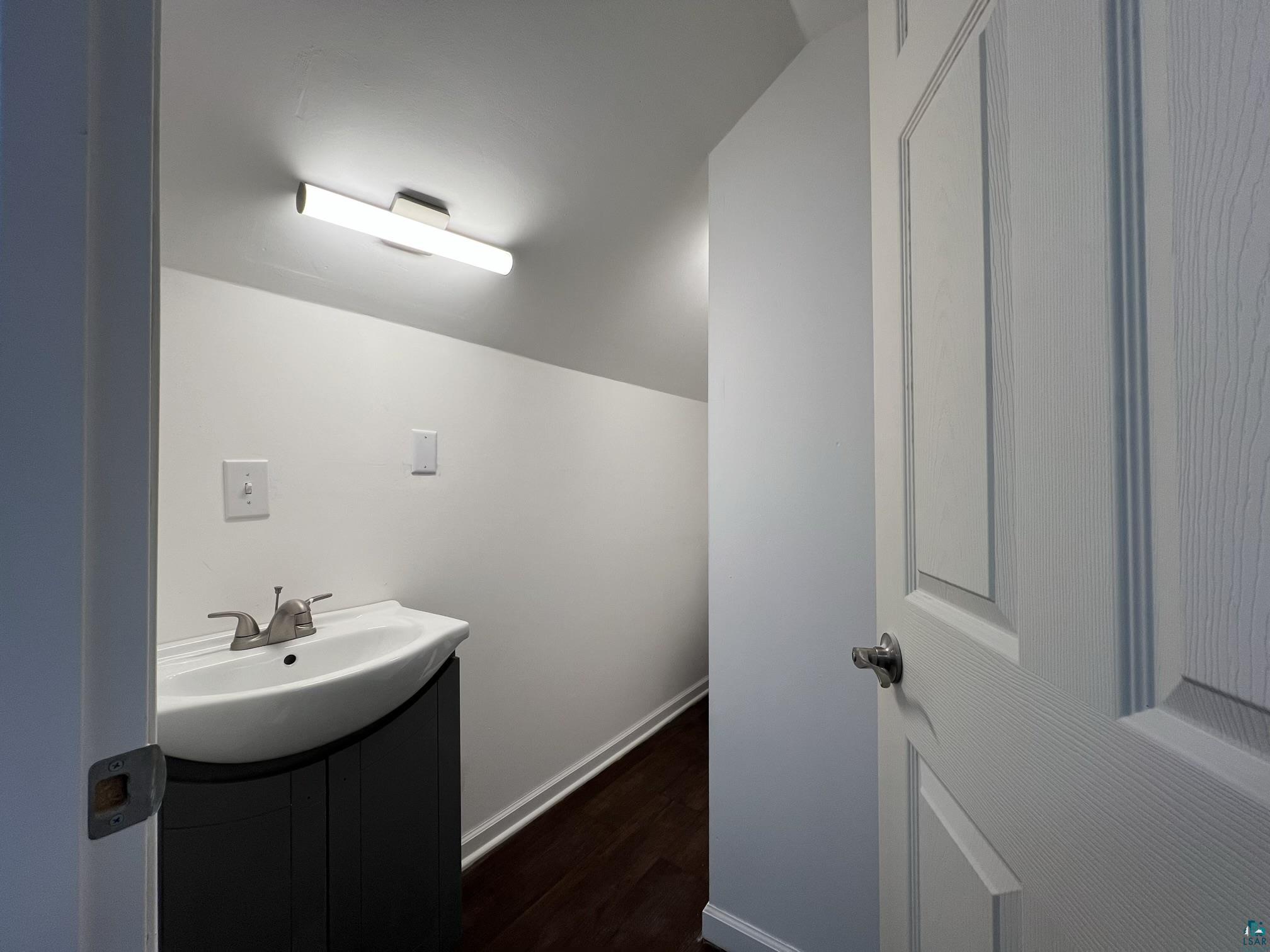 306 7th Street West Ashland, WI 54806 - Photo 17 of 25 Bathroom featuring vanity and dark wood-type flooring