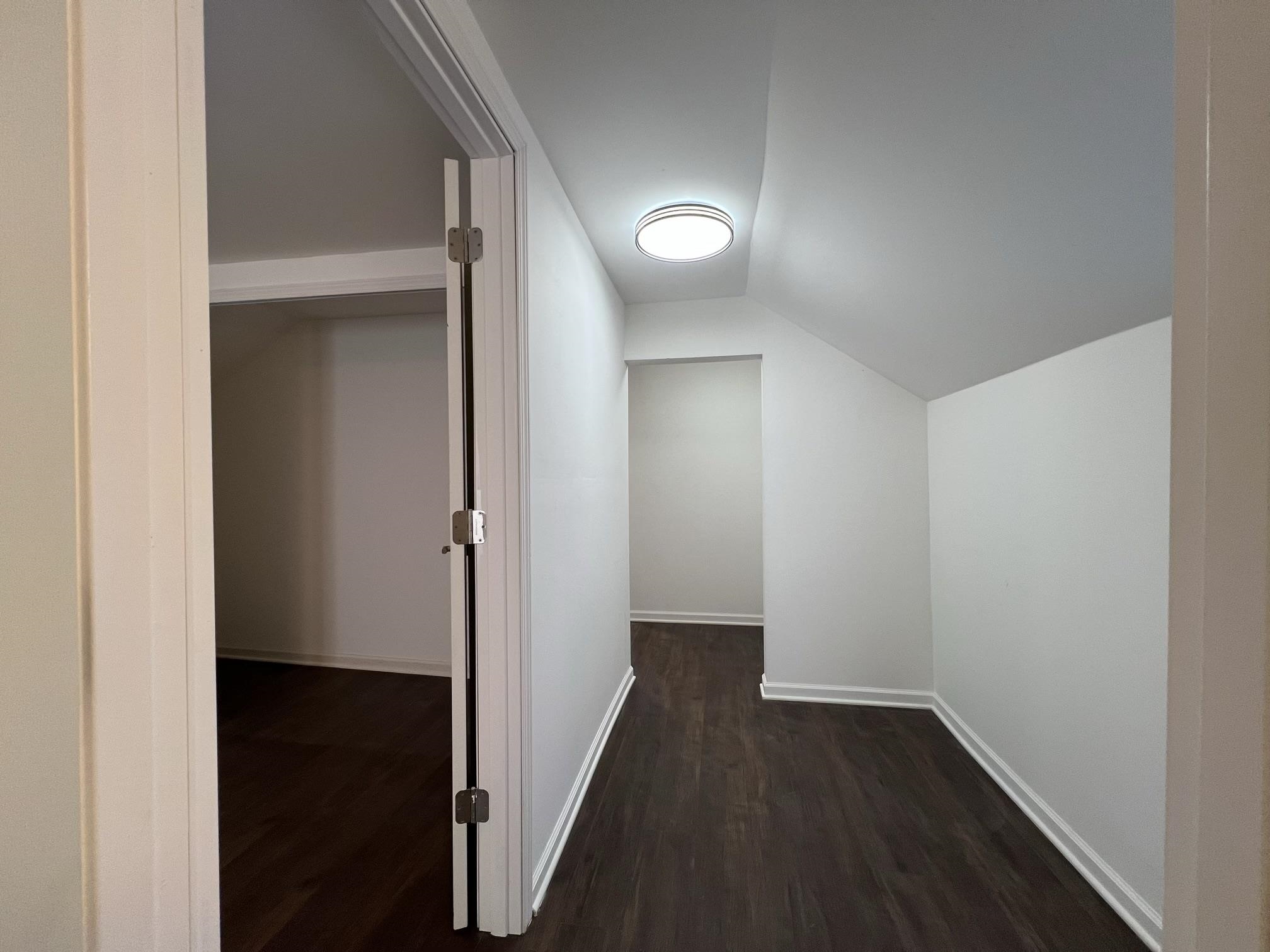 306 7th Street West Ashland, WI 54806 - Photo 19 of 25 Hallway featuring lofted ceiling and dark wood-style flooring