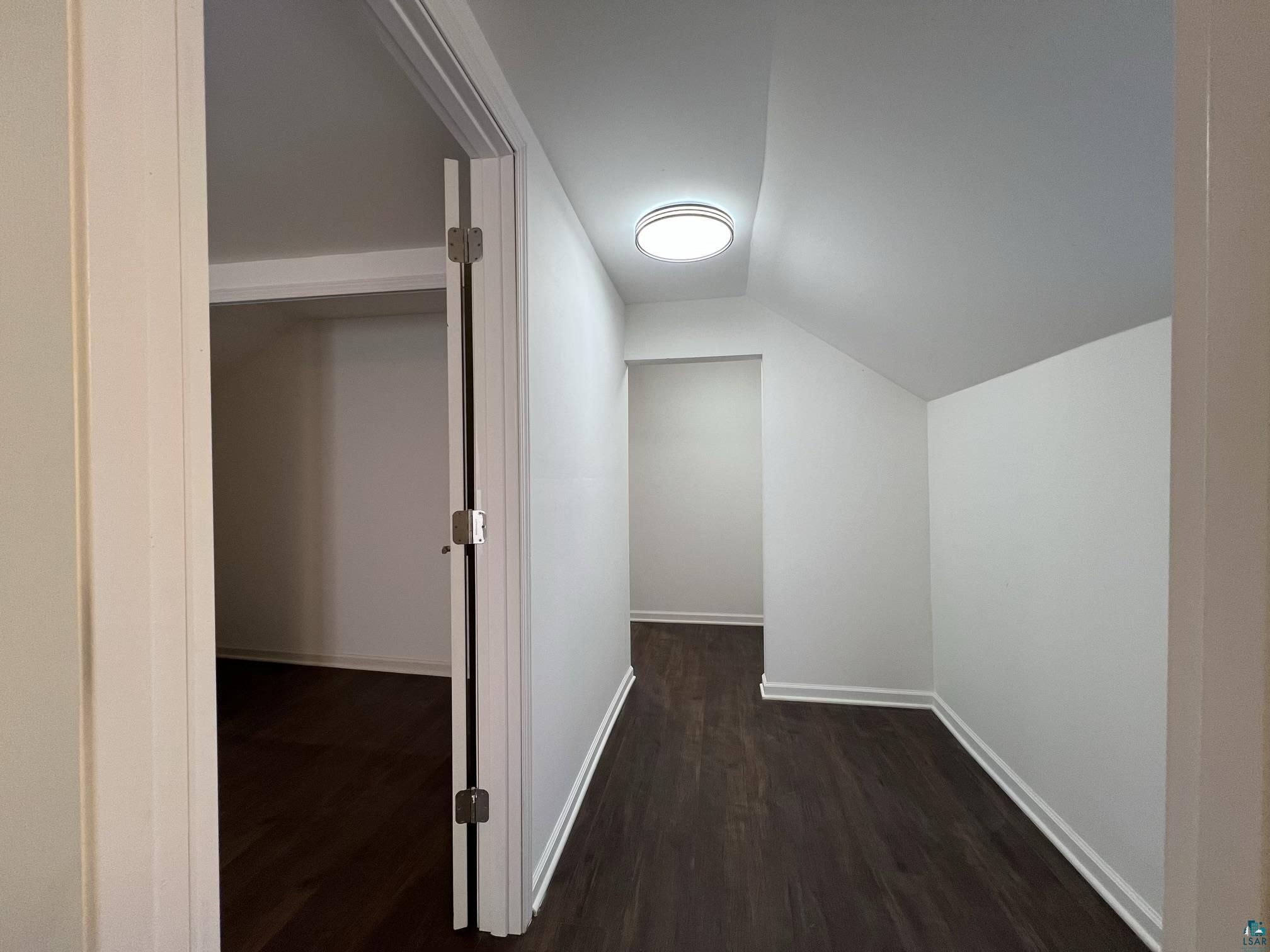 306 7th Street West Ashland, WI 54806 - Photo 19 of 25 Hallway featuring lofted ceiling and dark wood-style flooring