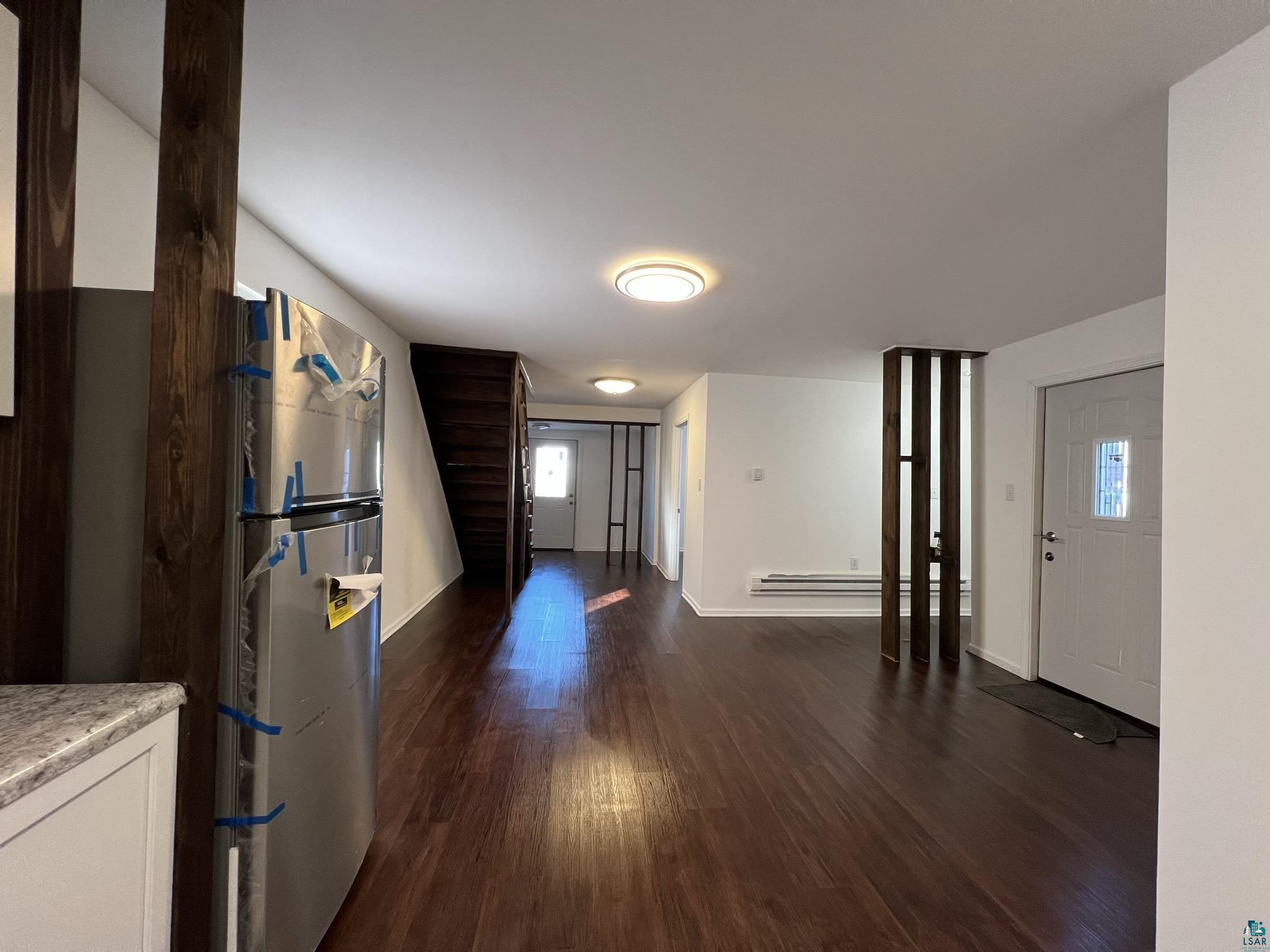 306 7th Street West Ashland, WI 54806 - Photo 5 of 25 Entrance foyer with dark wood-type flooring and a baseboard heating unit