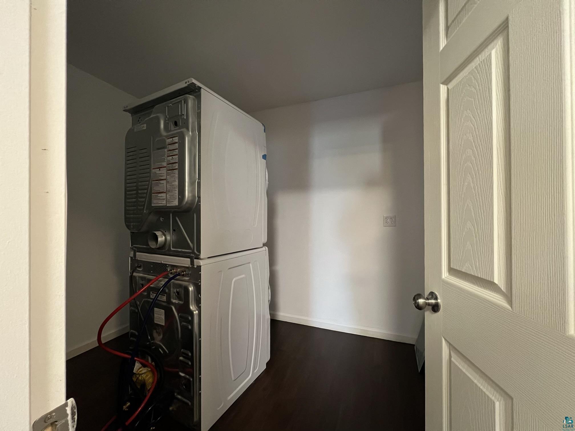 306 7th Street West Ashland, WI 54806 - Photo 8 of 25 Utility room with stacked washer / dryer