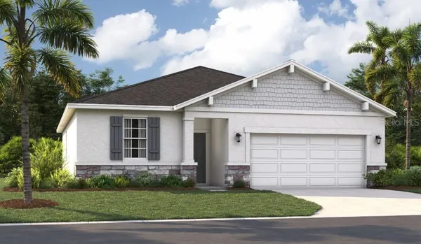 a front view of a house with a garden and yard