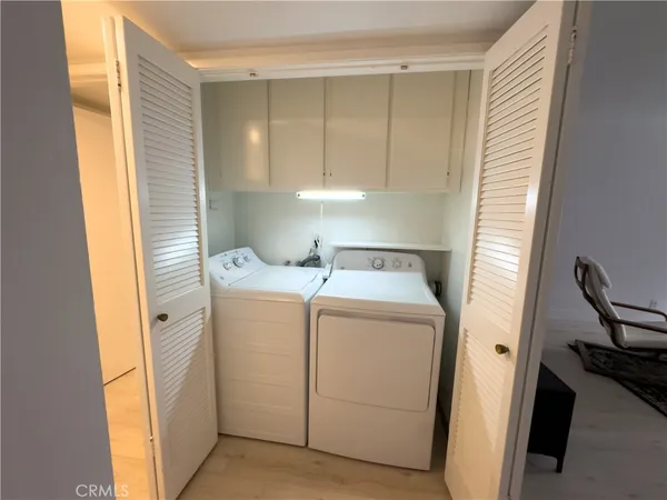 a view of storage and utility room with washer and dryer