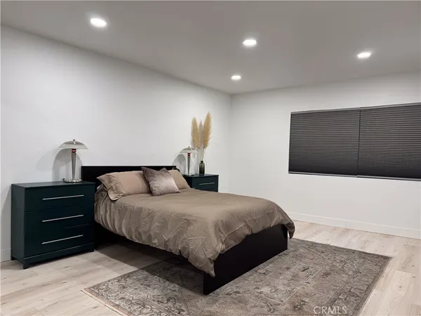 a bedroom with a bed and a night stand