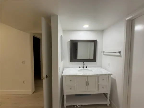 a bathroom with double sink and two mirror