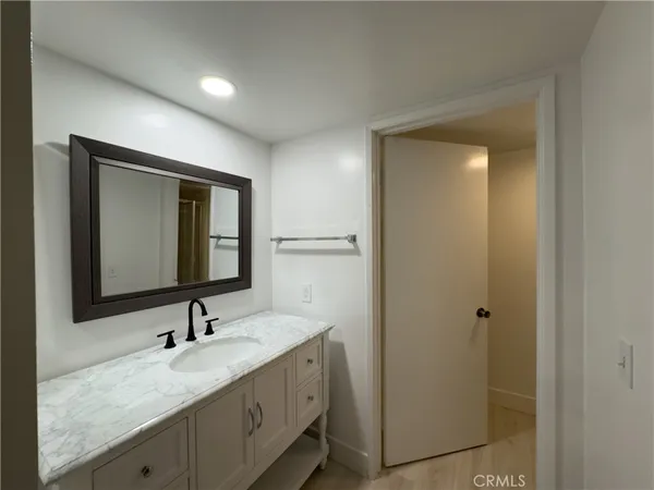 a bathroom with a double vanity sink and a mirror