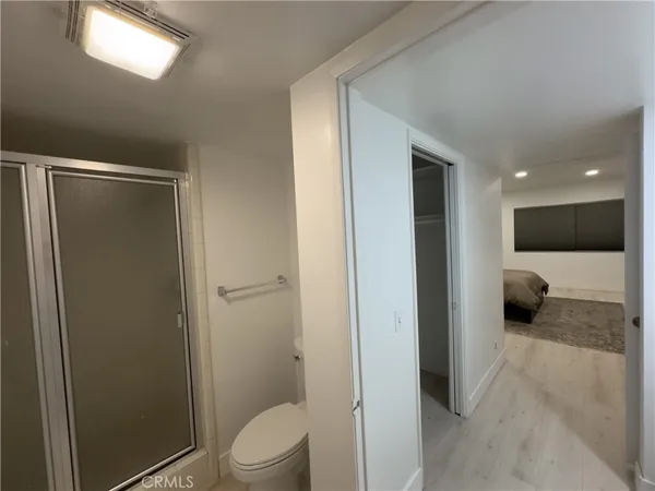 a bathroom with a toilet and a shower