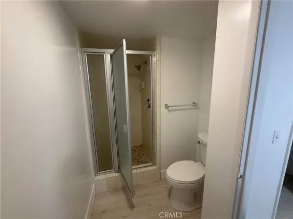 a bathroom with a toilet and a shower