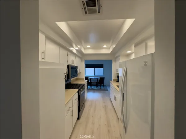 a kitchen with a refrigerator and a sink