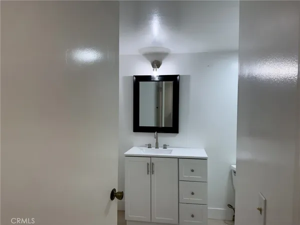 a bathroom with double vanity sink and mirror
