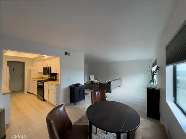 a kitchen with granite countertop a refrigerator stove top oven a sink and dishwasher