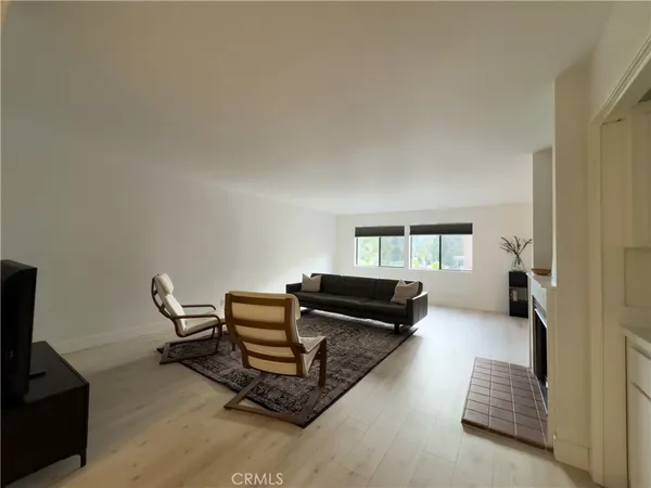 a living room with furniture a air conditioner and a window