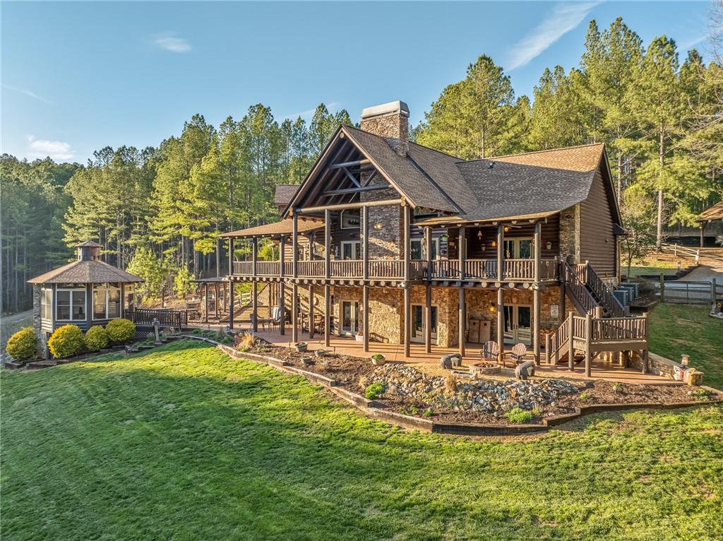 a view of a house with a big yard and potted plants