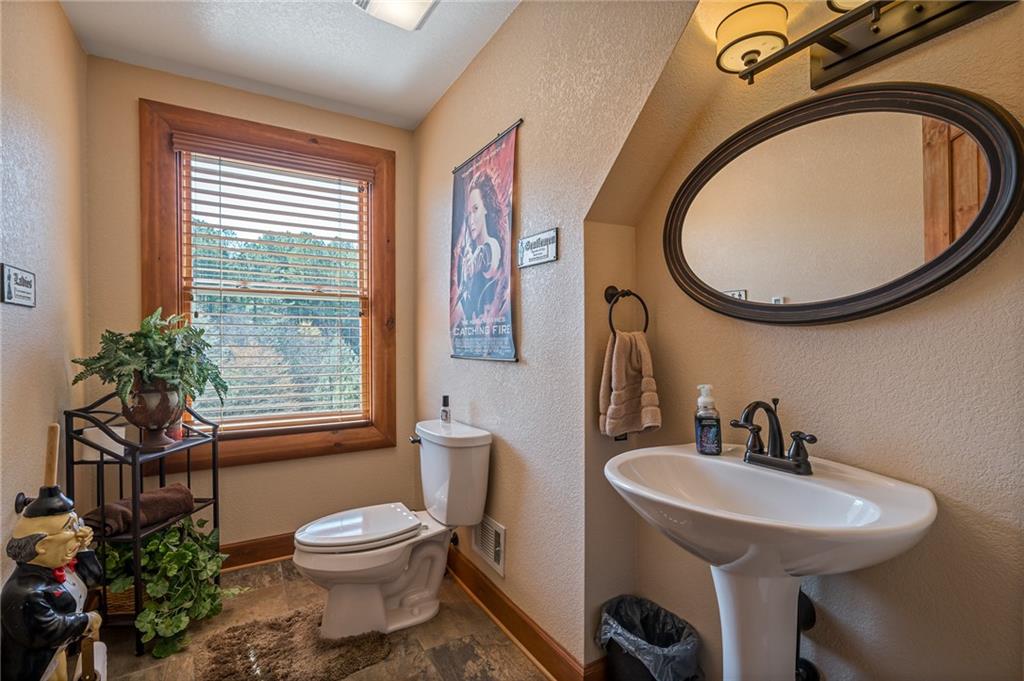 415 Kestrel Rdg Circle Murphy, NC 28906 - Photo 51 of 104 a bathroom with a toilet sink and mirror